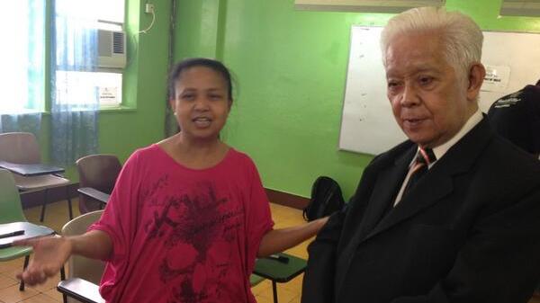FIRST DAY. Comelec chair Sixto Brillantes Jr with the first voter in Hong Kong to cast her vote for the 2013 elections. Photo from Brillantes' Twitter account
