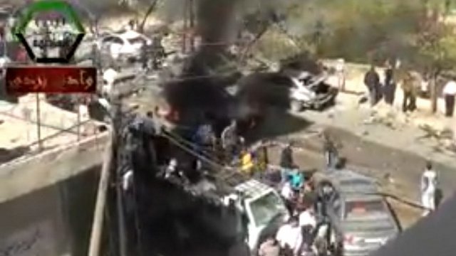 FEARS MOUNT. An image grab taken from a video uploaded on YouTube and provided by Nabad al-Aasima (Capital Pulsation) non profit organization on October 25, 2013 allegedly shows people gathering on the site of a car bomb attack in Suq Wadi Barada near Damascus. AFP PHOTO/ Nabad al-Aasima