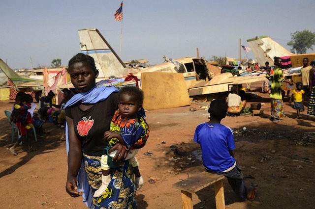 ESCAPING THE VIOLENCE. A displaced woman holds her child near Mpoko airport where 100,000 people have taken shelter in Bangui on January 8, 2014. Eric Feferberg/AFP