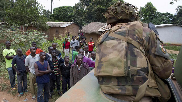 TALKS. A photograph dated December 6 and made available by the French Army Communications Audiovisual office (ECPAD) on December 9 shows a French soldier speaking with locals during operation Sangaris, in Central African Republic. Photo by Denniel Melanie/EPA