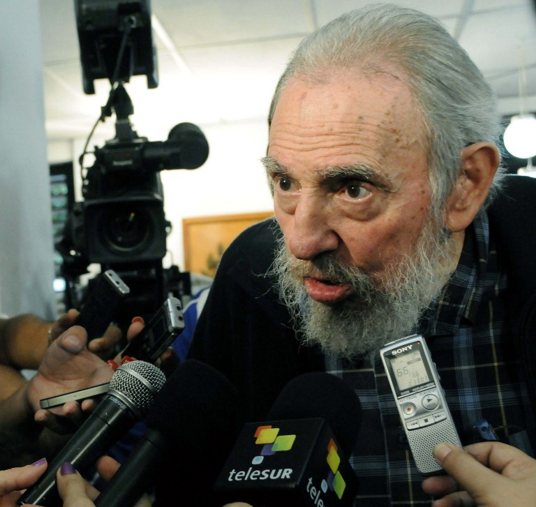 This handout photo from AIN taken and received on February 3, 2013 shows former Cuban president Fidel Castro talks to the media after casting his vote at a polling station in Havana. AFP PHOTO / Marcelino VAZQUEZ HERNANDEZ / AIN