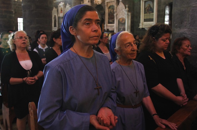 CATHOLICS IN SYRIA. Nuns attend the mass held for 3 Christian men, killed in the predominately Christian village of Maalola, at al-Zaytoun Church for the Roman Catholic, in Damascus, Syria, 14 September 2013. EPA/Youssef Badawi