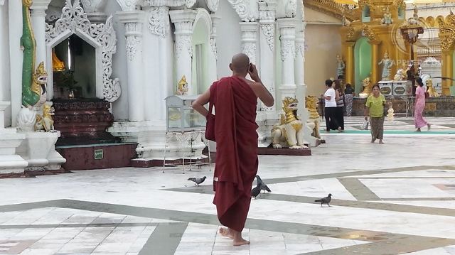 GOING MOBILE. A monk speaks on his mobile phone in Myanmar's iconic Shwedagon Pagoda. The country is expecting a boom in Internet and smartphone use after the government awarded licenses to two foreign telecommunication firms. Photo by Rappler/Ayee Macaraig, 2013 SEAPA Fellow