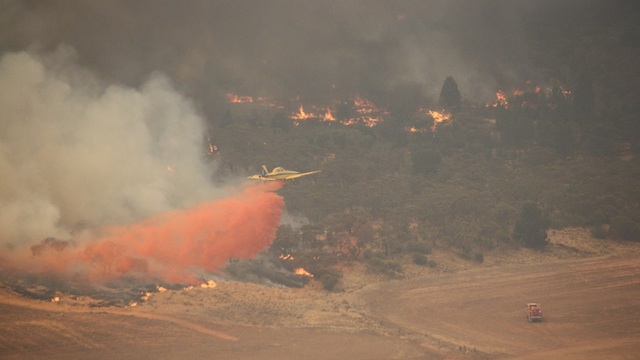 FIGHTING THE FLAMES. A firefighting aircraft working on flames in Victoria, Australia, 18 January 2014. Image courtesy of the Victoria Country Fire Authority