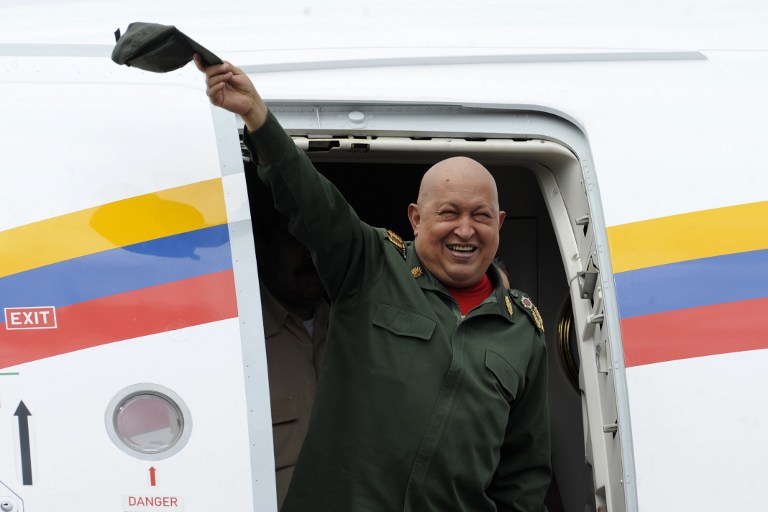 Venezuelan President Hugo Chavez waves upon alighting from the plane upon landing at the airport in Tachira, Venezuela, on October 20, 2011. Chavez passed away on March 5, 2013 in Caracas after a long fight with cancer, Venezuelan Vice President Nicolas Maduro announced. AFP PHOTO/ Leo RAMIREZ