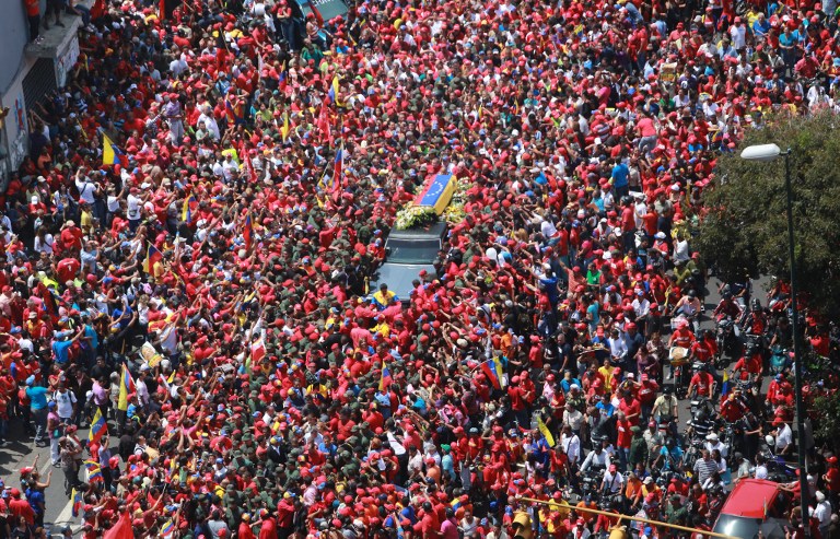 'CHAVEZ LIVES' Handout picture released by Miraflores presidential palace press office showing an aerial view of the funeral cortege of late Venezuelan President Hugo Chavez on its way to the Military Academy, on March 6, 2013, in Caracas. AFP PHOTO/PRENSA MIRAFLORES