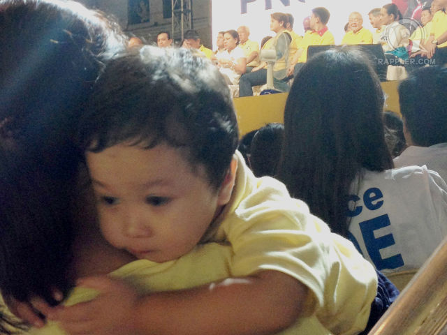 OUR FUTURE. A child rests on his mother's shoulder while Team PNOY candidates promise to make his future bright. 