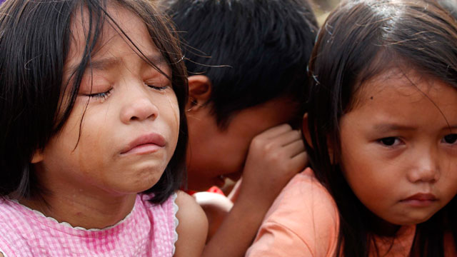 VULNERABLE. Child survivors, who escaped after their village was attacked by alleged armed men, wait for help in typhoon-devastated Tacloban City. File photo by Dennis M. Sabangan/EPA