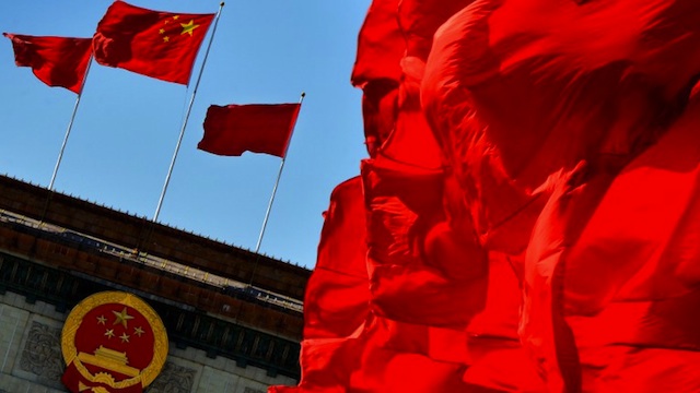 FLYING PROUD. Chinese flags fly over the Great Hall of the People in Beijing on November 13, 2012. AFP/Mark Ralston