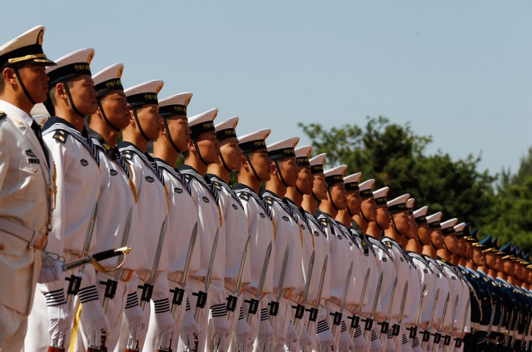 Chinese military troops stand at attention at the Bayi Building in Beijing on September 18, 2012. Larry Downing/Pool/AFP