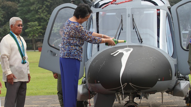 NEW CHOPPERS: The wife of defense secretary Voltaire Gazmin performs the ceremonial pouring of the champagne. Photo from Armed Forces of the Philippines