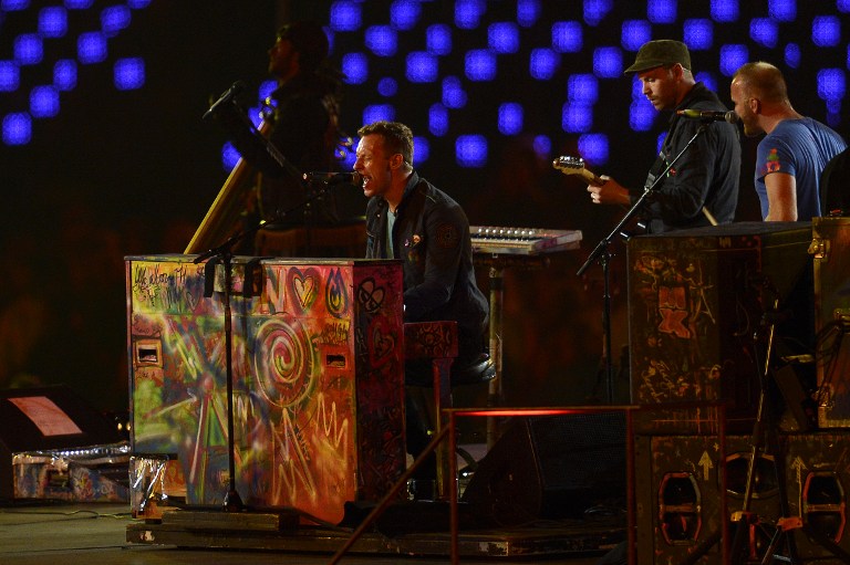 COLDPLAY LIVE. Chris Martin, Guy Berryman, Jon Buckland and Will Champion of British rock band Coldplay perform during the closing ceremony of the London 2012 Paralympic Games at the Olympic Stadium in east London on September 9, 2012. AFP PHOTO / ADRIAN DENNIS