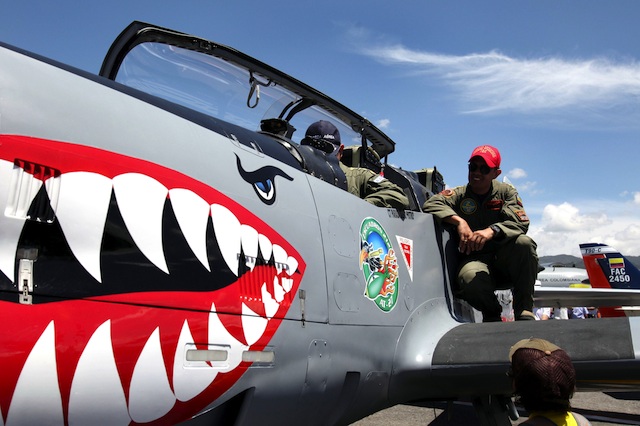 COLOMBIAN AIR POWER. A pilot in his aircraft and members of the Colombian Air Force (FAC) participate in the 6th Aeronautical Fair F-Air 2013 at the international airport Jose Maria Cordova in Rionegro, Antioquia, Colombia, 13 July 2013. EPA/Luis Eduardo Noriega