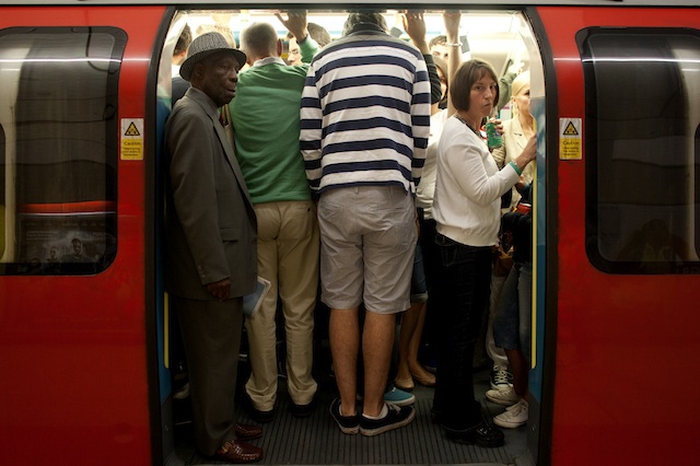 TOO TALL FOR THE TUBE. Commuters board a tube train at Green Park underground station during the 2012 London Olympic Games in London Britain, 04 August 2012. EPA/Tal Cohen