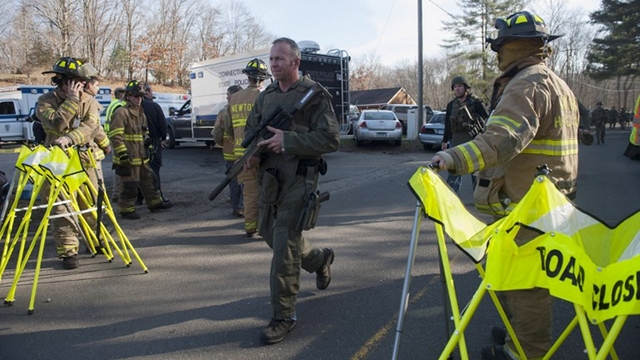 ON ALERT. Connecticut State Police walk near the scene of an elementary school shooting on Friday in Newtown, Connecticut. Photo by Douglas Healey/Getty Images/AFP