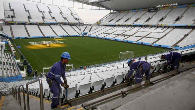 RACING TO FINISH. Workers secure scaffolding to add a row of seats inside the unfinished Arena Corinthians stadium, in Sao Paulo, Brazil days before the 2014 World Cup. Photo by Diego Azubel/EPA