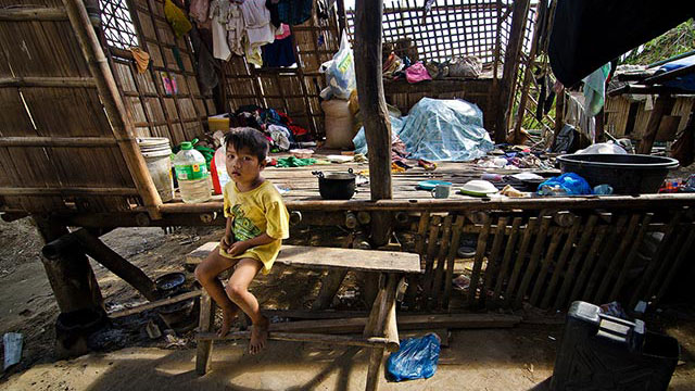 STILL UNREPAIRED. The house of Arnel Ancuna in Ajuy, northern Iloilo, is still unrepaired 19 days after Yolanda. Arnel takes on jobs repairing their neighbors' houses to earn a living. Shown in the photo is his son Lloyd Ancuna, 5 years old. Emmanuel Lerona of Typhoon Yolanda Story Hub Visayas