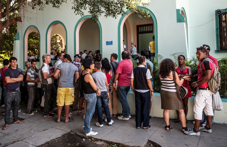 NOW FREE TO TRAVEL. Cubans queue outside a Migration Office to request new passports, on January 14, 2013 in Havana. AFP PHOTO/YAMIL LAGE