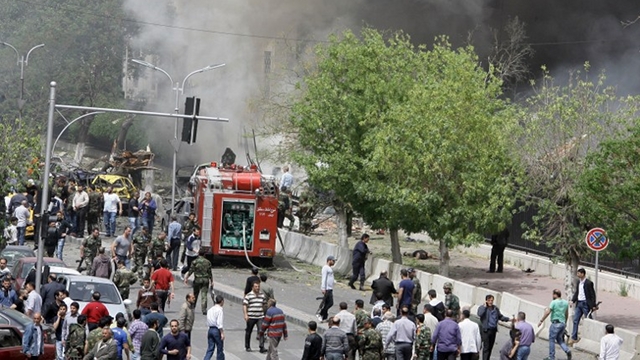 CAR BOMB. People inspect the scene of a deadly car bomb explosion which rocked central Damascus on April 8, 2013. The blast, which was followed by intense gunfire, occurred near the Syrian central bank causing deaths and injuries, according to Syria's state television. AFP/Louai Beshara 
