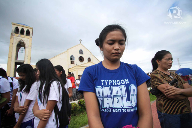 MOMENT OF SILENCE. Residents of Cateel, Davao Oriental observe a moment of silence on the first anniversary of Super Typhoon Pablo (Bopha), 4 December 2013. Photo by Karlos Manlupig/Rappler