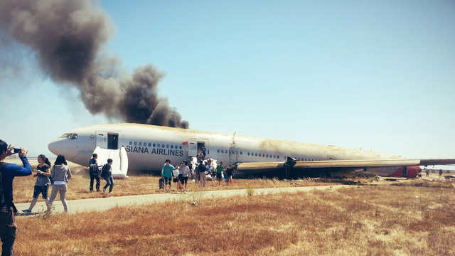 CRASH. Passengers evacuate the Asiana Airlines Boeing 777-200 that crashed while landing at the San Francisco Airport. Photo by David Eun via Path.com