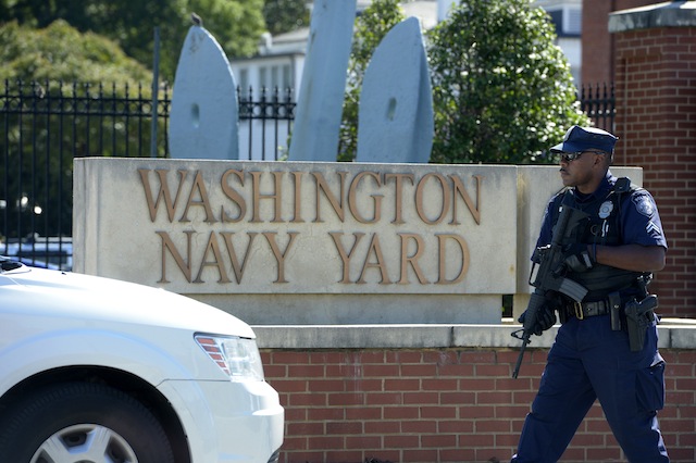 A HUNT? A police officer guards the main gate of the Navy Yard in Washington, DC, USA, 17 September 2013. EPA/Shawn Thew
