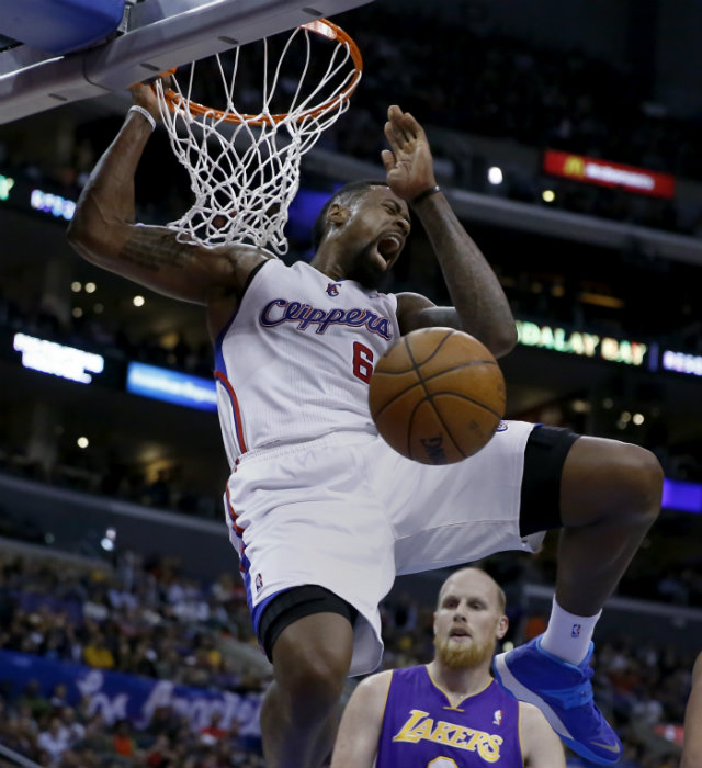  INSULT TO INJURY. Los Angeles Clippers center DeAndre Jordan throws one down with Los Angeles Laker Chris Kaman looking on helplessly on Friday, Jan. 10. The Clippers pounded the Lakers 123-87. Photo by Paul Buck/EPA
