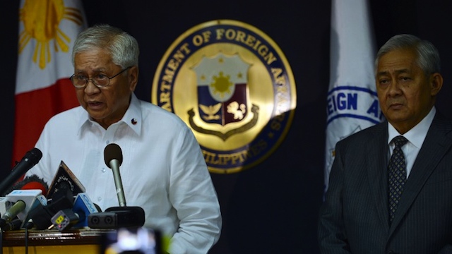 SEE YOU IN COURT, CHINA. Philippine Foreign secretary Albert del Rosario (L) reads a statement while the country's solicitor general Francis Jardeleza listens during a press conference in Manila on January 22, 2013. AFP PHOTO/TED ALJIBE