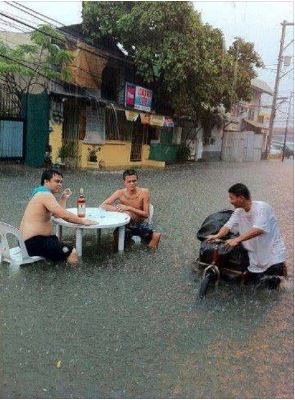 No unstoppable monsoon can stop this men from enjoying a drink. Photo from Facebook