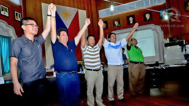 WINNERS. Mayor Manuel Sagarbarria and Woodrow Maquiling Sr. with Board of Canvasser Chairman Jerome Brilliantes raise their arms for the win. Photo by Romualdo Señeris II