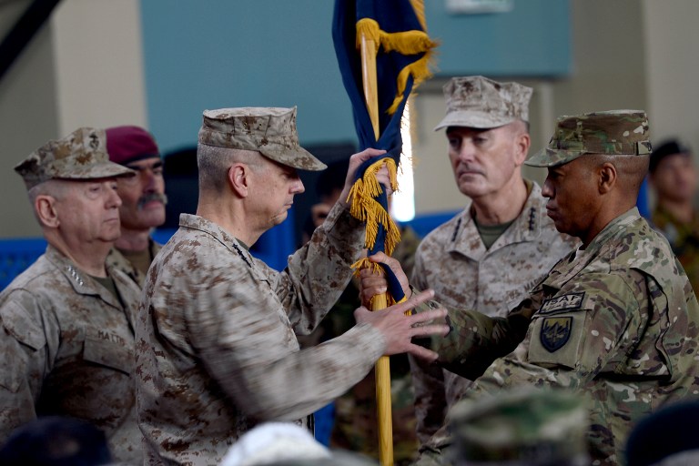 TURN OVER. Former NATO commander US General John Allen (3rd L) hands over a flag to US General Joseph F. Dunford (2nd R) as he takes over as commander of NATO in Afghanistan at the ISAF headquarters in Kabul on February 10, 2013. Massoud Hossaini/AFP