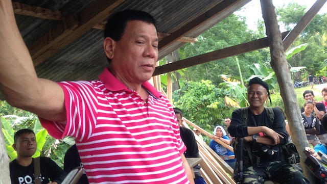 TOUGH MAYOR. In this file photo, Davao City Mayor Rodrigo Duterte is with soldiers released by the NPA in the hinterlands of Davao City. Photo by Karlos Manlupig/Rappler