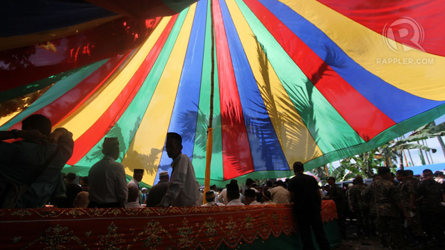 FESTIVE MOOD. Colorful buntings, flags and tents as well as the ebullient music from the kulintang mark the Bangsamoro assembly in one of the most heavily armed camps of the MILF. Photo taken by Karlos Manlupig