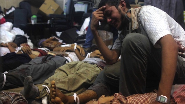 GRIEF. A man grieves as he looks at one of many bodies laid out in a make shift morgue after Egyptian security forces stormed two huge protest camps at the Rabaa al-Adawiya and Al-Nahda squares where supporters of ousted president Mohamed Morsi were camped, in Cairo, on August 14, 2013. Photo by AFP / Mosaab el-Shamy