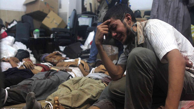 BLOODY CRACKDOWN. A man grieves as he looks at one of many bodies laid out in a make shift morgue after Egyptian security forces stormed two huge protest camps at the Rabaa al-Adawiya and Al-Nahda squares where supporters of ousted president Mohamed Morsi were camped, in Cairo, on August 14, 2013. Photo by AFP/Mosaab El-Shamy