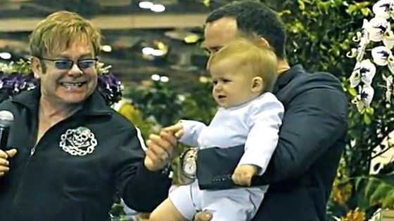 HAPPY DADS, HAPPY BABY. Elton John with David Furnish and Zachary in a video taken at Marina Bay Sands. Screen grab from YouTube (BratPrince84)