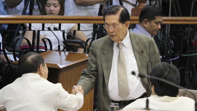 'HOPE YOU'RE RIGHT.' Senate President Juan Ponce Enrile shakes hands with Sen Edgardo Angara who voted for the RH bill. In his speech, Enrile told RH proponents he hopes they will be proven right. Photo by Senate PRIB 