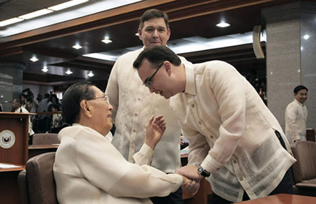 LINE DRAWN. Cayetano says he and Enrile are "not best friends but not enemies" but a line was drawn after their feud over Senate funds. In the photo, they shake hands at the opening of the 16th Congress. File photo by Joseph Vidal/Senate PRIB