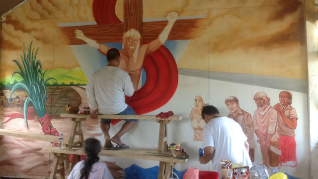 NEW LOOK. DIHON artists do their share of helping the community by painting the community chapel's new mural.