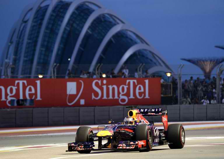VETTEL IN SINGAPORE. Red Bull driver Sebastian Vettel of Germany drives into the pitlane during the third practice session of the Formula One Singapore Grand Prix on September 21, 2013. AFP / Manan Vatsyayana