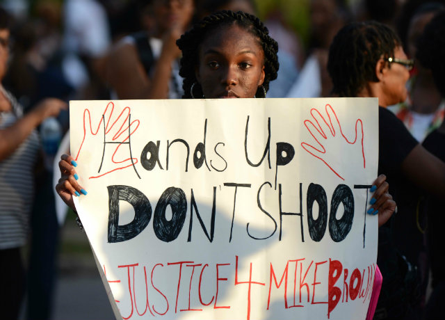 JUSTICE. Protesters gather on West Florissant Avenue in Ferguson, Missouri, USA on August 14. Photo by Robert Rodriguez/EPA