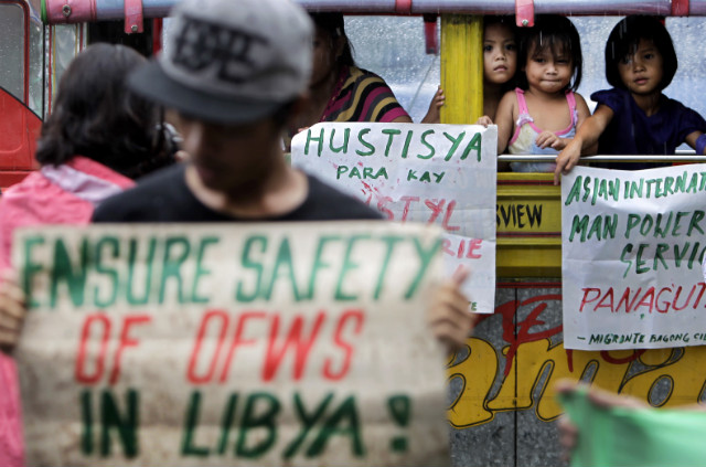 FOR FILIPINOS IN LIBYA. Filipino children hold placards during a protest outside the Department of Foreign Affairs in Manila, the Philippines, August 5, 2014. More countries moved to evacuate their nationals from Libya where the fighting between rival militias escalated. Photo by Ritchie Tongo/EPA