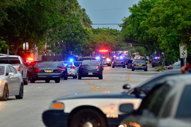 Police fill the street at the scene of a shooting which killed seven people including the gunman at an apartment building in Hialeah, Florida, USA. Photo by EPA/Gaston De Cardenas
