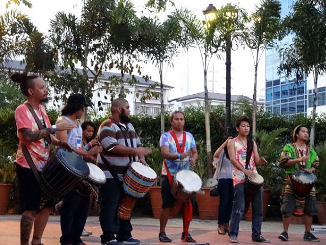 Djembe drummers play in a drum circle for the sunset spin jammers