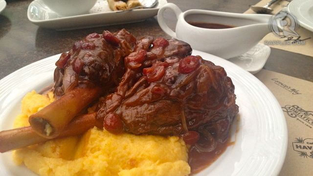 BRAISED LAMB SHANK. Tender lamb braised with wine, cranberry, honey and saffron sauce. This is so flavorful that it's perfect for sharing. Another reason why you must try this dish is the mashed corn (you read it right: CORN).
