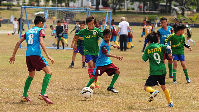 SWEATING IT. Under the summer heat, Football for Peace players challenge teams from private schools in Manila