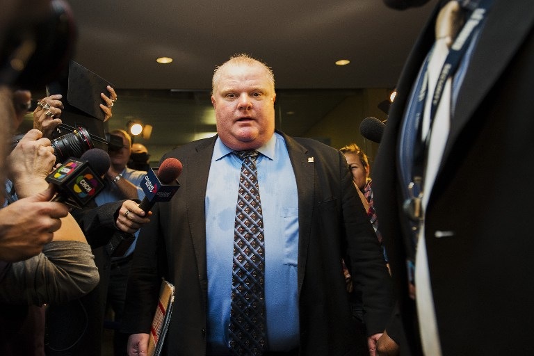LAME DUCK. In this file photo, Toronto Mayor Rob Ford is swarmed by media at City Hall after City Council striped him of emergency management powers on November 15, 2013 in Toronto, Canada. Aaron Vincent Elkaim/Getty Images/AFP