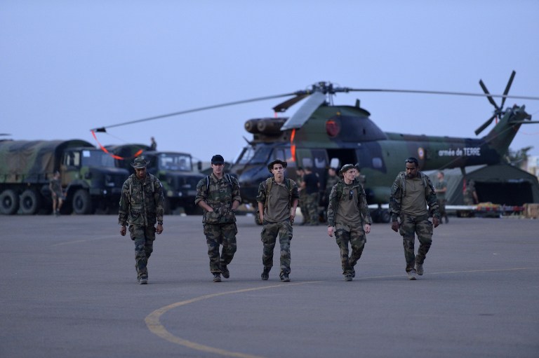 IN MALI. French soldiers from the 5th RHC (Combat Helicopter Regiment) walk on the flight path on January 20, 2013 at the 101st airbase near Bamako. AFP PHOTO / ERIC FEFERBERG