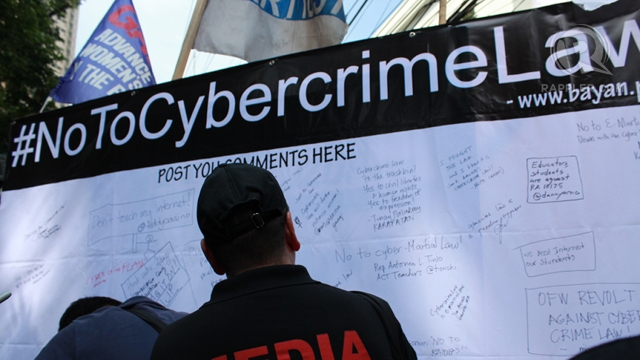 FREEDOM WALL. Protesters write their comments on a freedom wall in front of the Supreme Court, which issued a temporary restraining order on the Cybercrime Prevention Act. Photo by Hoang Vu 