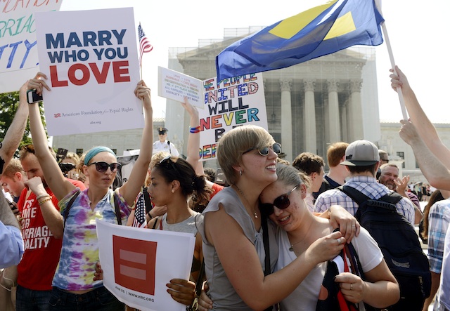 VICTORY. US university students Mollie Wagoner (2-R) and Sharon Burk (R), a same-sex couple that have been dating for a year, celebrate with supporters of gay and lesbian rights outside the Supreme Court after the ruling on California's Proposition 8, in Washington DC, USA, 26 June 2013. Photo by EPA/Michael Reynolds